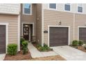 Inviting entrance with a dark wood door, stone accents, and a glimpse of the lovely interior details at 16038 Red Buckeye Ln, Huntersville, NC 28078