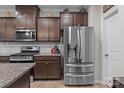 Well-equipped kitchen with stainless steel refrigerator, stylish cabinets, and modern appliances at 16038 Red Buckeye Ln, Huntersville, NC 28078
