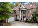 Classic brick home boasts a spacious driveway and attached two-car garage at 16614 Ruby Hill Pl, Charlotte, NC 28278