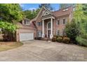 Beautiful brick home offers mature landscaping and a welcoming entrance at 16614 Ruby Hill Pl, Charlotte, NC 28278