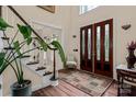 Grand foyer features a staircase, hardwood floors, and a statement front door at 16614 Ruby Hill Pl, Charlotte, NC 28278