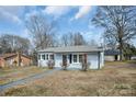 Charming single-story home with freshly painted exterior and well-manicured front lawn at 200 W Shannonhouse St, Shelby, NC 28152
