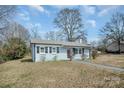 Charming single-story home with freshly painted exterior and well-manicured front lawn at 200 W Shannonhouse St, Shelby, NC 28152