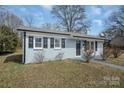 Charming single-story home with freshly painted exterior and well-manicured front lawn at 200 W Shannonhouse St, Shelby, NC 28152