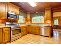 Cozy kitchen with wood cabinets, granite countertops, and stainless steel appliances at 235 John Rainey Rd, Salisbury, NC 28147