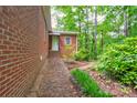 View of the side of a brick house with well-kept landscaping at 235 John Rainey Rd, Salisbury, NC 28147