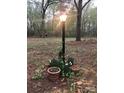 Outdoor light post surrounded by lush plants and decorative pots at 235 John Rainey Rd, Salisbury, NC 28147
