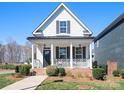 Charming two-story home with a covered front porch, decorative railings, and well-maintained landscaping at 2363 Shanklin S Ln, Denver, NC 28037