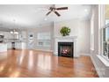 Bright and airy living room featuring hardwood floors, fireplace, ceiling fan and natural light at 2363 Shanklin S Ln, Denver, NC 28037