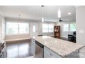 Bright open kitchen features island and view to living area at 2408 Dora Dr, Charlotte, NC 28215