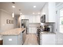 Bright and spacious kitchen featuring stainless steel appliances and a large center island at 2408 Dora Dr, Charlotte, NC 28215