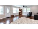 A view of the open living room, bathed in natural light from large windows at 2408 Dora Dr, Charlotte, NC 28215