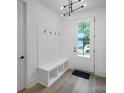 Inviting entryway with coat hooks, a built-in bench, and a view to the exterior at 2512 Park Rose Ln # 16, Charlotte, NC 28204