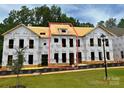 New construction home showing framing and Tyvek wrap, hinting at modern design at 282 Gilead Rd, Huntersville, NC 28078
