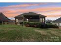 A beautiful screened porch and well-maintained lawn complete this backyard at 304 Wintergreen Ct, Kings Mountain, NC 28086