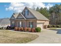 Charming brick home with an attached garage and beautifully landscaped yard at 304 Wintergreen Ct, Kings Mountain, NC 28086