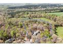 Expansive aerial shot showcasing the home's placement on a large, wooded lot with mature trees providing seclusion at 3249 Ivey Creek Rd, Maiden, NC 28650