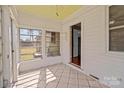 Bright sun room with white walls, tiled floors, and lots of windows at 325 Hurley School Rd, Salisbury, NC 28147
