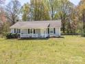 Charming single-story home with a cozy front porch and a large yard at 524 Catawba N Cir, Matthews, NC 28104