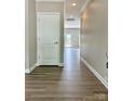 Welcoming hallway with wood-look flooring leads to other rooms in the house at 6008 Grassy Knoll Cir, Matthews, NC 28104