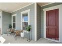 Comfortable seating on the covered front porch, perfect for relaxing and enjoying the neighborhood views at 7130 Irongate Dr, Indian Land, SC 29707
