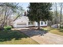 Well-maintained home with a two-car garage, long driveway, and mature trees at 916 Rollingwood Dr, Mount Holly, NC 28120