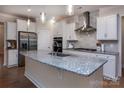 Modern kitchen with stainless steel appliances, granite countertops, and a stylish backsplash at 938 Moose Trl, Matthews, NC 28104