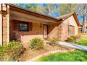 Inviting brick home exterior featuring a cozy porch and well-manicured landscaping at 106 Jason Ct, Fort Mill, SC 29715