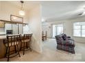 Open-concept living room and kitchen area with modern bar stools and plush seating at 106 Jason Ct, Fort Mill, SC 29715