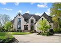 Beautiful two-story home with a circular driveway and a light colored brick exterior at 109 Redbird Ln, Weddington, NC 28104