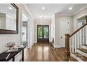 Bright foyer features hardwood floors, a front door with glass panes and white trim at 109 Redbird Ln, Weddington, NC 28104