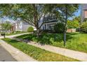 Suburban home with lush green lawn and mature shade tree, showcasing the property's curb appeal at 11222 Huntington Meadow Ln, Charlotte, NC 28273