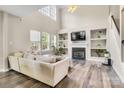 Bright living room with vaulted ceilings, fireplace, built-in shelving, and large windows for plenty of natural light at 11222 Huntington Meadow Ln, Charlotte, NC 28273