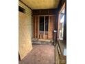Unfinished porch with wooden boards and yellow ceiling, awaiting restoration at 119 Mitchell St, Salisbury, NC 28144