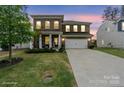 Charming brick two-story home featuring a manicured lawn and a spacious two-car garage at 121 Little Kennerly Dr, Mooresville, NC 28115