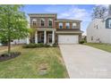 Charming brick two-story home featuring a manicured lawn and a spacious two-car garage at 121 Little Kennerly Dr, Mooresville, NC 28115