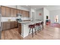 Modern kitchen featuring granite countertops, a kitchen island with seating, stainless steel appliances, and tiled backsplash at 12110 Anne Blount Aly, Huntersville, NC 28078