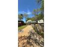 Long driveway leading to a well-kept home, framed by mature trees and lush greenery at 1232 Rosada Dr, Charlotte, NC 28213