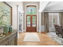 Elegant foyer with hardwood floors, high ceilings, and a view of the outdoors at 12627 Ninebark Trl, Charlotte, NC 28278