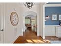 Bright foyer with hardwood floors, designer lighting, and open archways at 1407 Becklow Ct, Wesley Chapel, NC 28079