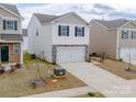 Charming two-story home with white siding, stone accents, a two-car garage, and a well-maintained lawn at 14217 Wilson Mac Ln, Charlotte, NC 28278