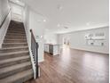 Bright open concept living room with hardwood floors, stairs and plenty of natural light at 14217 Wilson Mac Ln, Charlotte, NC 28278