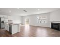 Bright living room and kitchen area with fireplace and hardwood floors, and a sliding door to the backyard at 14217 Wilson Mac Ln, Charlotte, NC 28278