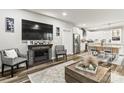 Open-concept living room with modern fireplace, large TV, and kitchen view at 154 Shields Dr, Lincolnton, NC 28092