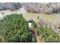 Breathtaking aerial view showcasing a stunning home nestled among lush trees and waterfront at 233 Conifer Way, Shelby, NC 28150