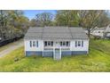 Charming single-story home featuring blue shutters, a covered front porch, and a well-maintained lawn at 2420 Kannapolis Hwy, Concord, NC 28027