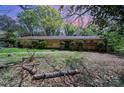 Modest single-story home showcasing its brick facade, simple landscaping, and a yard covered with spring foliage at 340 Sardis N Rd, Charlotte, NC 28270