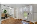 Bright foyer with hardwood floors, decorative front door, and views into the dining room at 361 Nance Rd, Stanfield, NC 28163