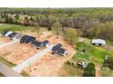 Wide aerial view showcasing new construction homes with surrounding acreage and outbuildings at 3957 Miller Rd, Salisbury, NC 28147