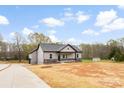 Charming single-story home features gray siding, stone accents, and an attached two-car garage at 3957 Miller Rd, Salisbury, NC 28147